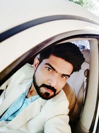 Portrait of young man in car