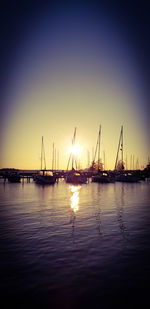 Sailboats in marina at sunset