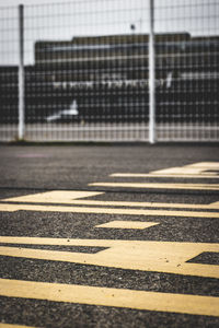 Close-up of zebra crossing on road in city