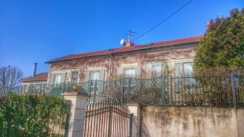 Low angle view of built structure against blue sky