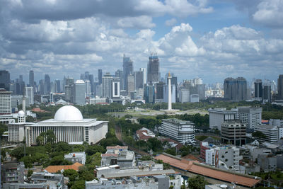 Cityscape against cloudy sky
