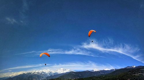 People paragliding against sky