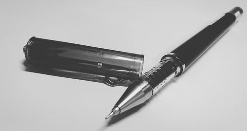 Close-up of pen with cap on white background