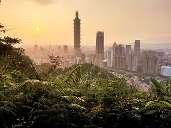 View of buildings in city at sunset