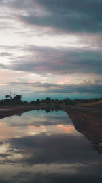 Scenic view of lake against dramatic sky