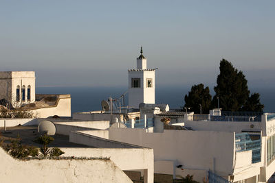 High angle view of houses by sea against sky