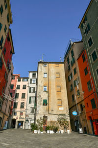 Low angle view of residential buildings against blue sky