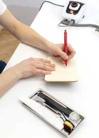 Cropped hands of man working on table