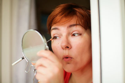 Close-up portrait of woman looking at camera