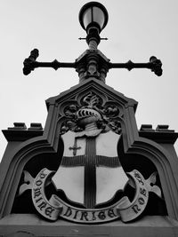 Low angle view of cross against sky