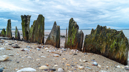 Panoramic shot of rocks on beach against sky