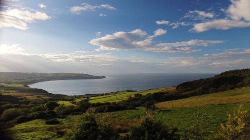 Scenic view of sea against cloudy sky