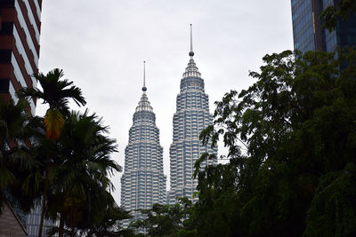 Spires of the petronas twin towers with cloudy background during a rainy day