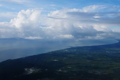 Scenic view of sea and mountains against sky