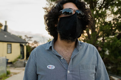 Portrait of man wearing sunglasses standing outdoors