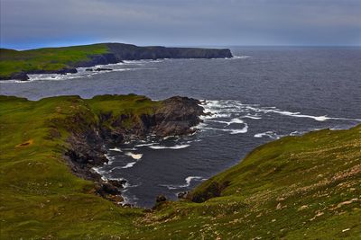 Scenic view of sea against cloudy sky