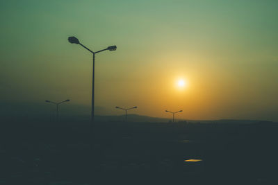 Silhouette of wind turbines at sunset