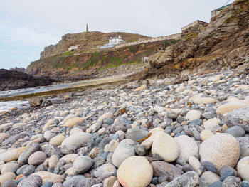 Surface level of rocks on shore against sky
