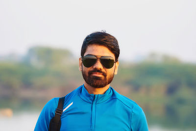 Portrait of man wearing sunglasses against sky