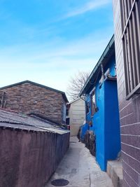 Alley amidst buildings against sky