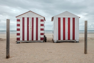 Lifeguard hut on beach against sky