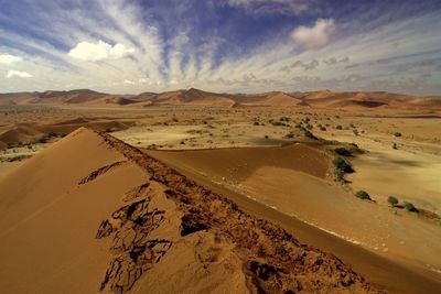 Barren landscape against clouds