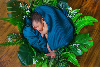 High angle view of baby sleeping in bed