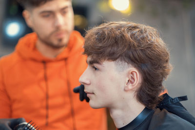Close-up of teenager at barbershop