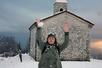 Girl winter overalls plays soft snow sunset landscape under church mountains in apuan alps tuscany