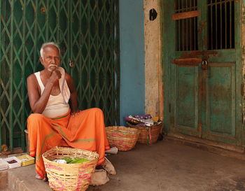 Man sitting on wicker basket