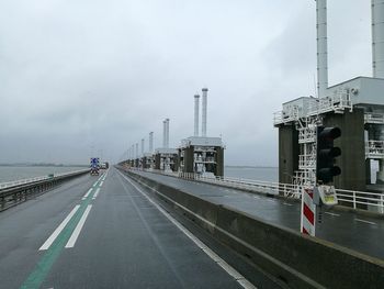 Vehicles on road against sky