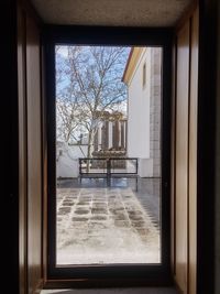 Building seen through window of house