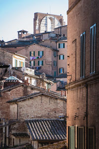 Low angle view of buildings in town against sky