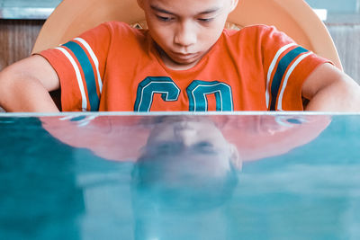 Reflection of boy on table