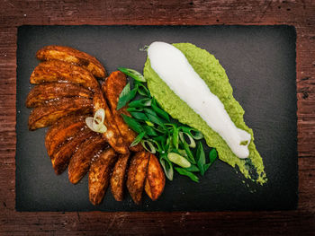 High angle view of fresh vegetables on table against black background