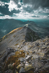 Scenic view of mountains against cloudy sky