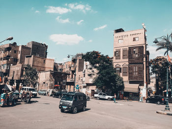 Cars moving on street against buildings in city