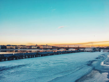 Bridge over river against sky during winter