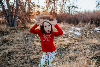 Young girl making a silly face wearing fun christmas clothes