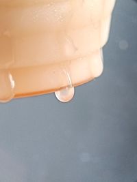 Close-up of wet glass against white background