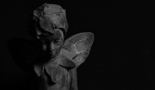 Close-up of statue against black background