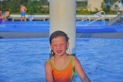 Happy little girl enjoying summer day in the swimming pool. cute girl enjoying summer at water park