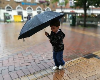 Boy walking on sidewalk