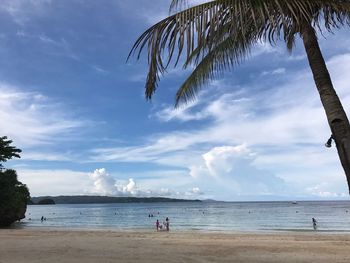 View of beach against cloudy sky