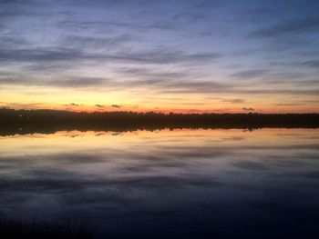 Scenic view of lake against romantic sky at sunset