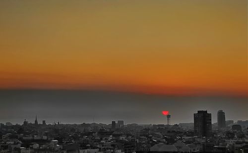 Cityscape against orange sky