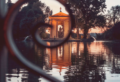 Reflection of building in lake against sky