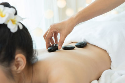 Young woman receiving lastone therapy in spa