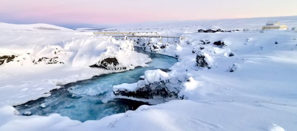 Scenic view of snow covered landscape against sky