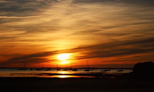 Scenic view of beach against sky during sunset